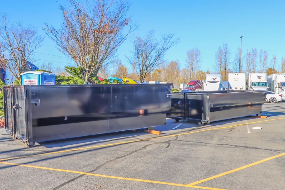 Professional dumpster rental service with roll-off container on residential driveway in Homestead